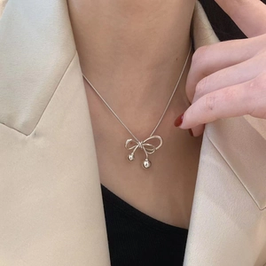 Elegant silver bow pendant necklace with double polished beads on a snake chain