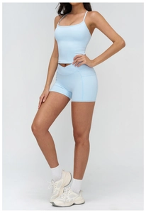 Detail view of light blue yoga set with crossover high waist shorts and U-neck sports bra