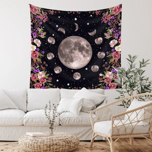 Detail of lunar phase tapestry with moon and floral patterns on white wall
