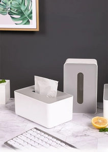 Detail of minimalist white textured tissue box with grey lid on marble table