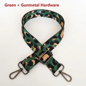 Detail of green leopard print nylon shoulder strap with gunmetal swivel hooks