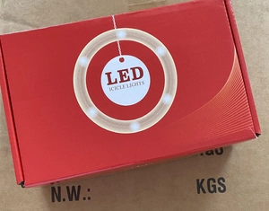 Retail packaging of LED icicle lights in a red box on a brown shipping carton for shipping