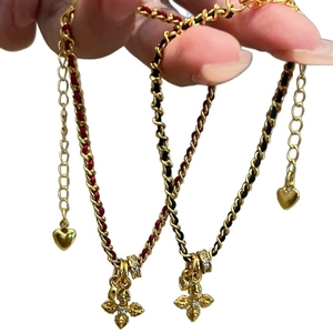 Vintage gold cross bracelets with red and black braided ropes and zircon stones