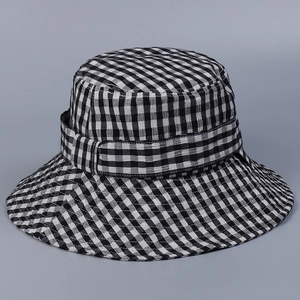 Detail shot of the black and white gingham check pattern and fine woven texture on the sun hat