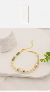 Detail of natural freshwater pearl bracelet with green gemstones and 18k gold plating
