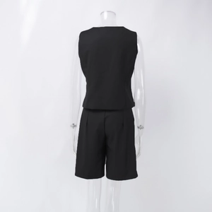 Back view of black two-piece set featuring a tailored vest and high-waist pleated shorts
