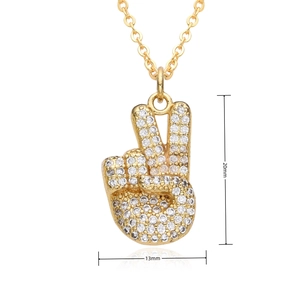 Macro shot of gold hip hop scissors gesture pendant with dimensions 20mm by 13mm