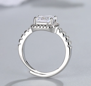 Detailed macro view of silver ring with large square zircon and adjustable open band