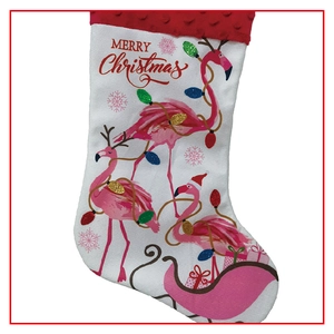 Detailed view of a white Christmas stocking featuring pink flamingos and red glitter accents