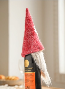 Detailed view of gnome wine bottle cover with grey beard and snowflake red hat