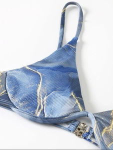 Detail of blue marble bikini top with ribbed fabric texture and silver buckle closure
