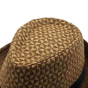 Close-up of the woven texture and black ribbon band on a brown straw fedora hat
