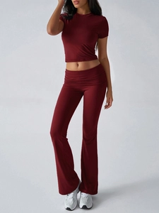 Slim fit burgundy two-piece set featuring short sleeve crop top and flared pants for women