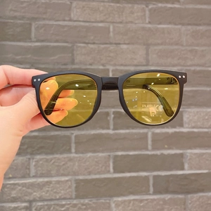 Detailed shot of yellow lens sunglasses with UV400 protection and CE certification