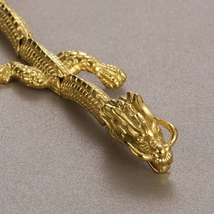 Detailed macro view of golden dragon head carving on 18k plated stainless steel bracelet