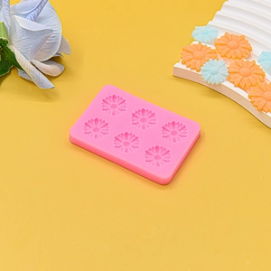 Detail of pink silicone daisy flower mold with six cavities for fondant and chocolate DIY