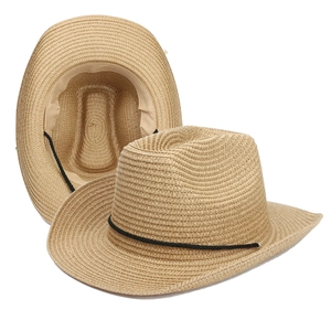 Detail view of woven straw cowboy hat showing natural texture and inner sweatband