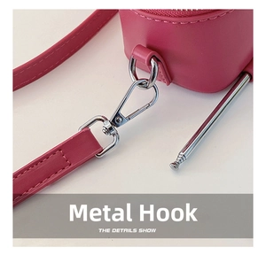 Detail view of pink leather bag with silver metal hook and telescopic antenna design
