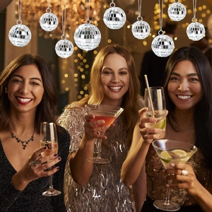 Silver mirror disco ball ornament reflecting party lights in a festive celebration scene