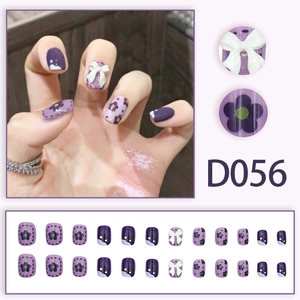Purple press-on nail kit D056 with 3D white bows and floral patterns in various sizes