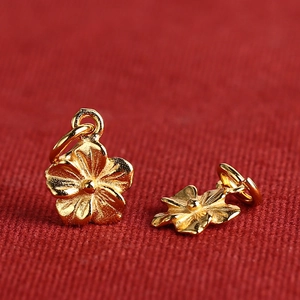 Gold-plated S925 silver flower pendant accessories with rings on red textured background
