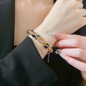 Close-up of vintage beaded bracelet with multi-color glass beads and golden details