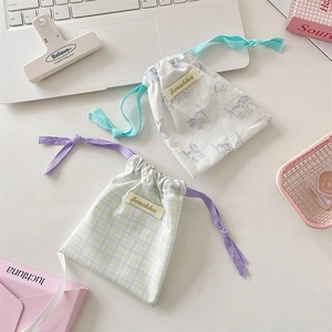 Detail of printed cotton drawstring pouches for lipstick and small travel items