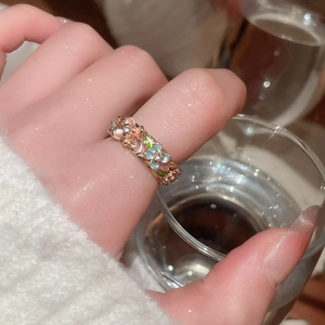 Detail of rose gold flower ring with colorful enamel petals and sparkling crystals