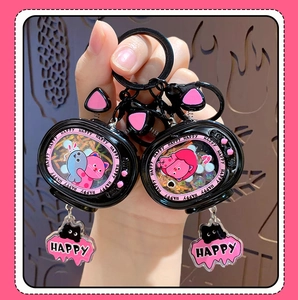 Detail view of cartoon cat TV keychain with pink glitter sand and metal chain