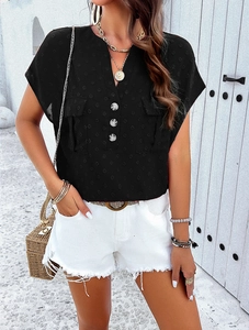 Detail of black V-neck short sleeve top with textured Swiss dot fabric and chest pockets