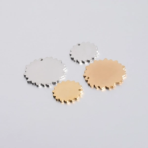 Detailed view of floral stainless steel pendants in gold and silver mirror finish