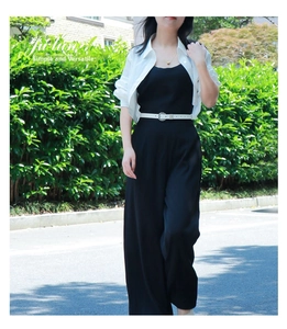 Outdoor shot of a chic summer outfit with black jumpsuit and white belt detailing