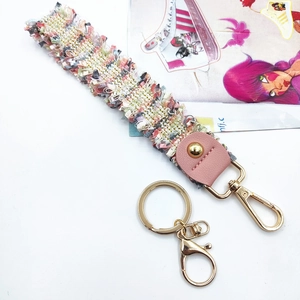 Colorful woven tassel lanyard with pink leather trim and golden lobster clasp