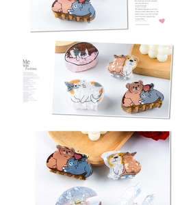 Detailed view of cute acetate hair claws featuring cartoon cat and dog animal designs