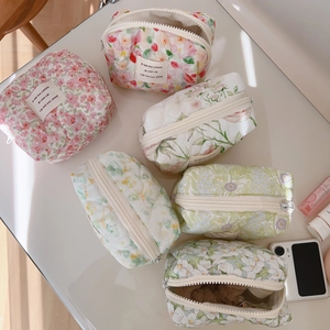 Quilted floral cotton makeup bag with soft padded texture and colorful flower prints