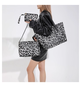 Detailed view of 3-piece leopard print bag set including tote and crossbody bags