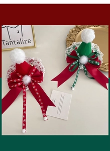 Detail of red and green Christmas hat hair clips with lace, satin ribbon and pom-pom decor