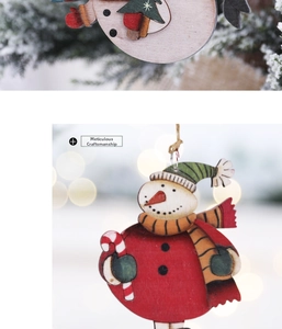 Close-up of wooden snowman Christmas ornament with fine laser-cut details and festive print