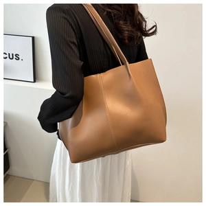 Side view of large vintage brown leather tote bag with soft texture for daily commute