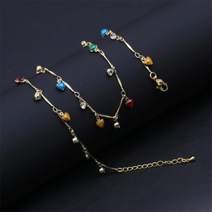 Detail of gold chain necklace with colorful glitter heart charms and rhinestone accents