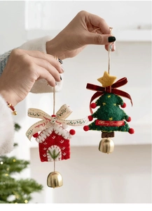 Close-up of handmade felt Christmas tree and house ornaments with bells and festive ribbons
