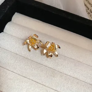 Vintage gold lily flower stud earrings with brushed metal finish in jewelry gift box