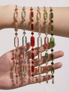 Detailed view of six colorful oval Czech glass bracelets with gold stainless steel settings