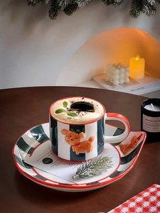 Detailed view of hand-painted striped ceramic mug set with 3D puppy relief on wooden table