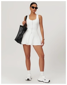 Detail of white athletic dress featuring a front zipper and U-shaped neckline