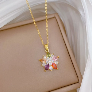 Macro shot of gold floral pendant with multi-color rhinestones in a jewelry box