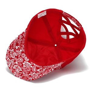 Detail of red bandana print baseball cap with elastic criss-cross ponytail back design