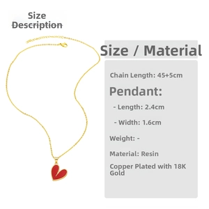 Detail showing the red heart pendant with gold beaded edges on a copper 18K gold necklace