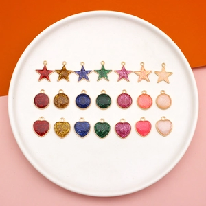 Macro view of colorful glitter resin charms in star, heart, and round alloy shapes