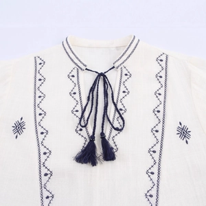 Bohemian white cotton blouse with deep blue floral embroidery and tassel neck ties